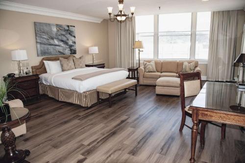 a bedroom with a bed and a living room at Haywood Park Hotel, an Ascend Collection Hotel in Asheville