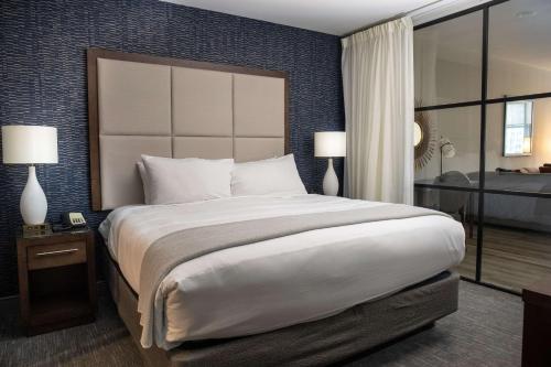 a bedroom with a large bed and a large window at Haywood Park Hotel, an Ascend Collection Hotel in Asheville