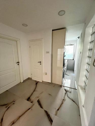 a room with a cracked floor and a door at No1 Apartments in heart of Sarajevo in Sarajevo