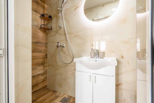a bathroom with a sink and a shower at Sumice Inn in Petrovac na Moru