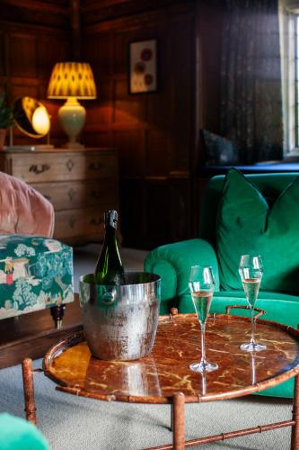a table with a bottle of champagne and two glasses at Boys Hall in Willesborough