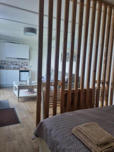 a room with a bed with a large wooden wall at Cozy Hut with the included Hot Tub-Prime Rentals in Karališkiai