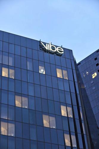 a nissos sign on the side of a building at Vibe Hotel Melbourne Docklands in Melbourne