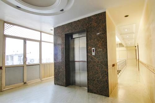 a hallway with a door in the middle of a building at FabHotel CS Jalandhar in Jalandhar