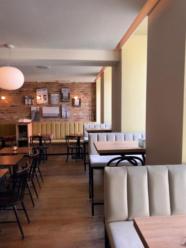 a restaurant with tables and chairs and a bar at Townhouse Maastricht & Spa in Maastricht