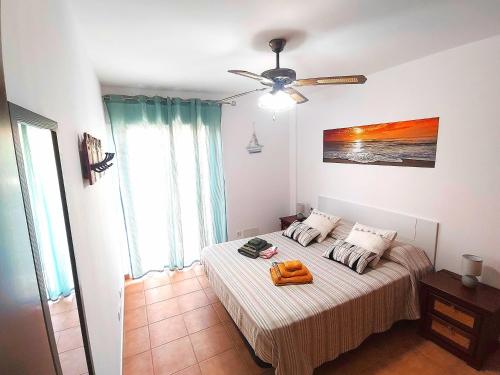 a bedroom with a bed and a ceiling fan at Casa Lara Fuerteventura in Corralejo
