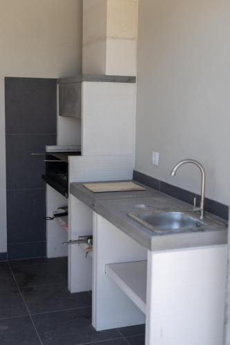 a kitchen with a sink and a counter at Correia Villa in Barcelos