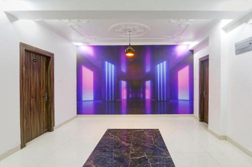 an empty room with purple walls and a dance floor at FabExpress Magadh Glory in Khagaul