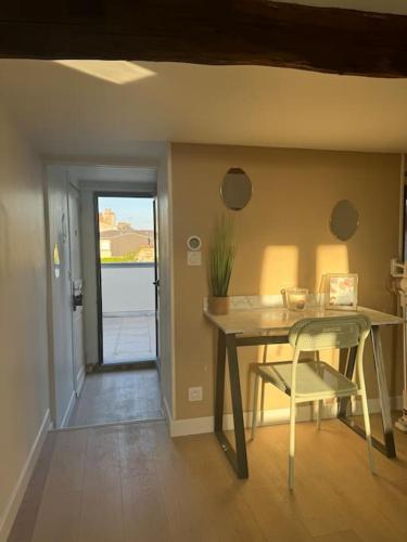 une salle à manger avec une table et une chaise dans l'établissement Le Rooftop - Terrasse vue Cathédrale - Netflix, à Orléans