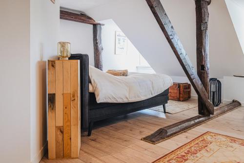 a bedroom with a bed in a attic at La Fornaccia in Anloo