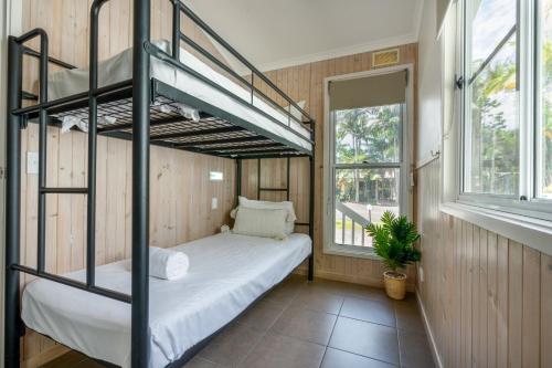 a room with a bunk bed and a window at BIG4 Tasman Holiday Parks - Ballina in Lennox Head