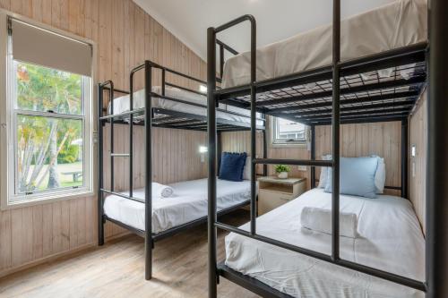 two bunk beds in a room with a window at BIG4 Tasman Holiday Parks - Ballina in Lennox Head