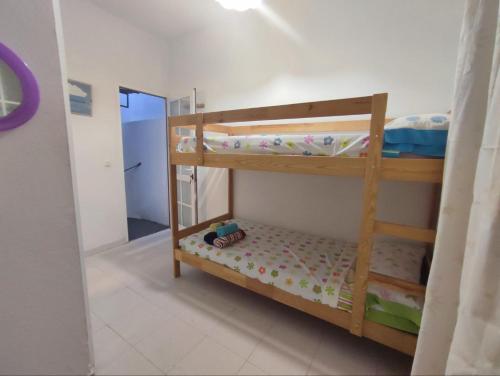 a bedroom with two bunk beds and a mirror at Casa Athenea in Conil de la Frontera