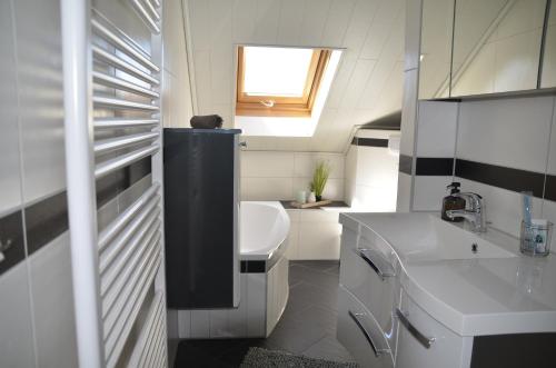 a small bathroom with a sink and a toilet at Ferienwohnung Brehm in Bad Staffelstein