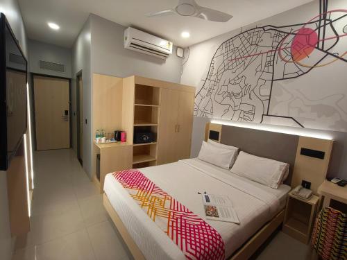 a bedroom with a bed with a drawing on the wall at Ginger Pondicherry in Puducherry