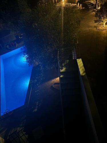 an overhead view of a swimming pool at night at Apartmani Milos - Meljine in Herceg-Novi