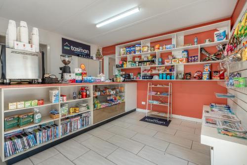 a grocery store with orange walls and shelves at BIG4 Tasman Holiday Parks - Ballina in Lennox Head