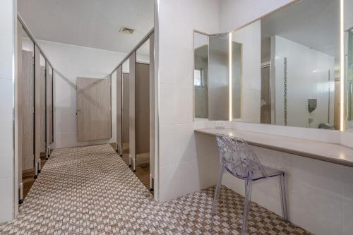 a bathroom with a chair and a vanity with a mirror at BIG4 Tasman Holiday Parks - Ballina in Lennox Head