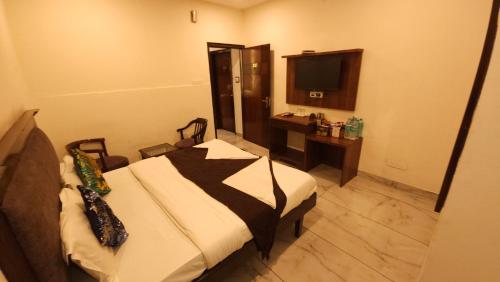 a hotel room with a bed and a television at Hotel Cityscape in Chandīgarh
