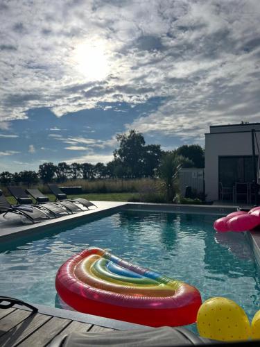 a swimming pool with several colorful tubes in it at Villa de Groupe avec Piscine, Jacuzzi et Vue Nature in Pierric