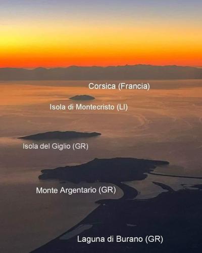 an island in the middle of the ocean at sunset at Il Belvedere - Cannelle beach Argentario - Tuscany in Monte Argentario