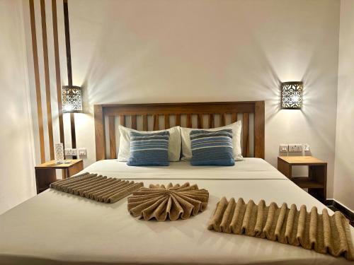 a bedroom with a bed with two towels on it at Reyna Resort By Cezere The Palm in Paje