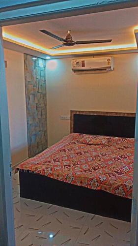 a bedroom with a bed and a ceiling fan at Vijay home stay in Sheva Nhava