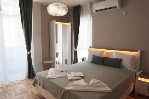 a bedroom with a large bed with towels on it at Apartments near to Burgas Free University in Burgas