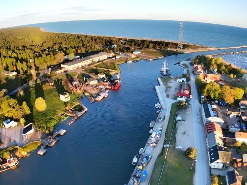 an aerial view of a river with boats docked at Lost & Found 3 - with 4 bikes in Pāvilosta