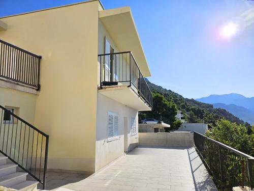 a white building with stairs and a balcony at New 2 Bedroom, 2 Bathroom Apartment in Pisak in Pisak