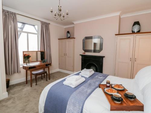 a bedroom with a bed with a tray of food on it at Abbey Vista in Whitby