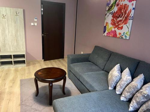 a living room with a couch and a table at Park Hotel Fairy in Chiflik