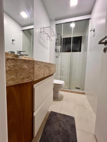 a bathroom with a sink and a toilet and a shower at Travelers Dream! in Arraial do Cabo