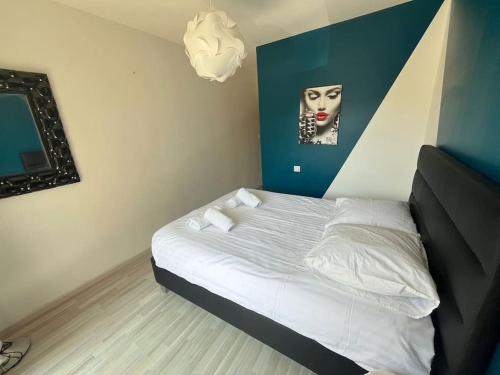 a bedroom with a bed with a picture of a woman at Le Balnéo in Thonon-les-Bains