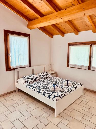 a bedroom with a bed in a room with wooden ceilings at Casa Al Piazzol in Alano di Piave