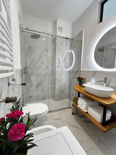 a bathroom with a shower and a sink and a toilet at DIVE RIVE LUXURY Apartment in Desenzano del Garda