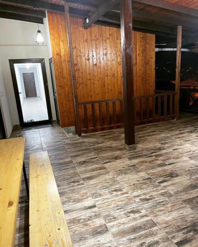 an empty room with wooden walls and a wooden bench at Coco Home in Buşteni
