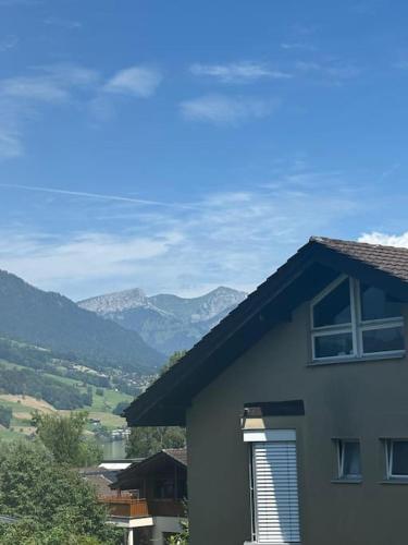 a house with a view of mountains in the distance at NH 6 Interlaken-Luzern I Lake I Mountain I connect in Sachseln