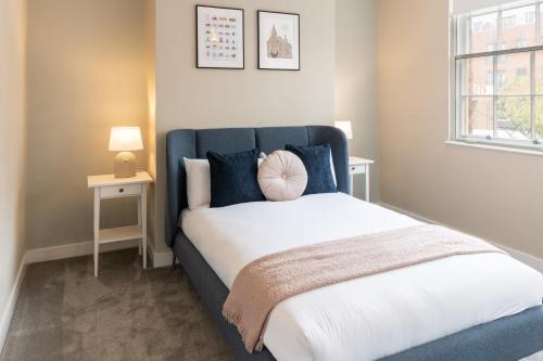 a bedroom with a large bed with a blue headboard at Host & Stay - The Quarter in Liverpool
