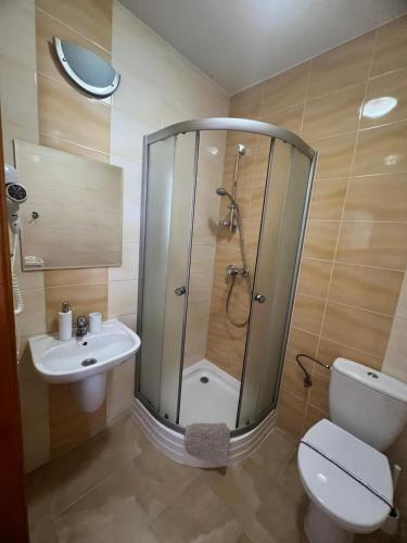 a bathroom with a shower and a toilet and a sink at Willa Balticus in Władysławowo
