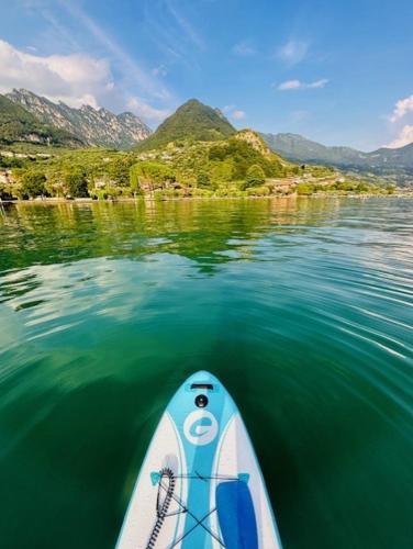 a paddle board in the water with mountains in the background at Dock House in Marone