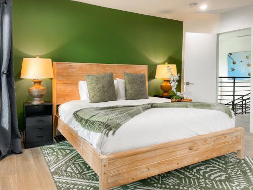 a bedroom with a large bed with a green wall at Villa Palma - Prime Location, Pool, Game Room, Outdoor Kitchen in Miami