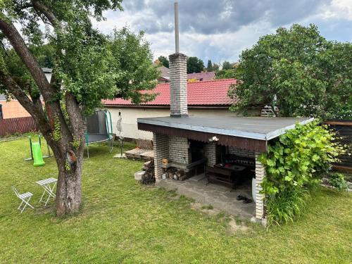 an outdoor fireplace in the yard of a house at Chalupa Jarka in Jablŭnka