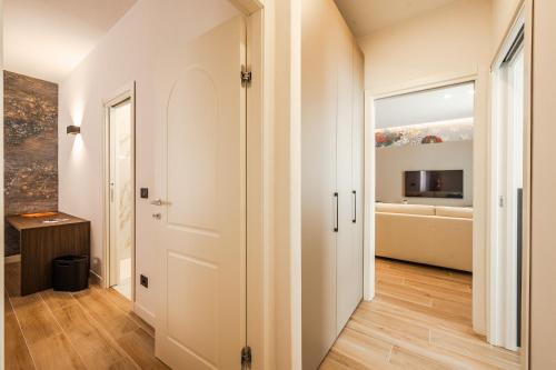 a hallway with a white door and a living room at 6 Isonzo - Luxury Stay Verona in Verona