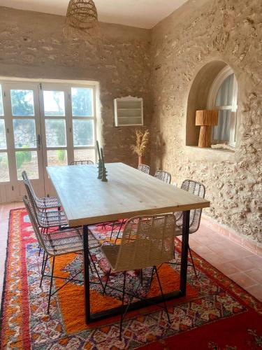 a dining room with a table and chairs at Adam house in Essaouira