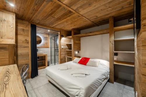 a bedroom with a large bed in a room with wooden walls at Chalet Grand Cru 14 pers-Abondance in Abondance