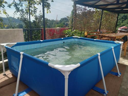 a pool of water with a chair in it at Семейная гостиница Гантиади in Batumi