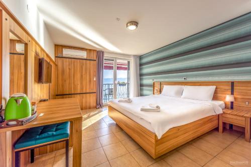 a bedroom with a large bed and a desk and a desk at Villa Marko - Trpejca in Ohrid