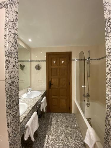 a bathroom with a sink and a shower at Parador de Vilalba in Villalba