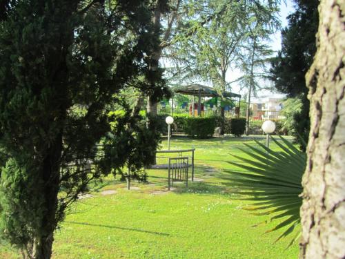 a park with a bench and a table in the grass at Hotel Giovanna in Pompei